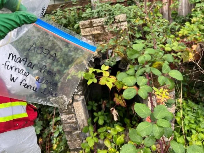 West of stockpile — Household waste — Hazardous Material: Possible asbestos in insulation wiring, hydrocarbons in containers