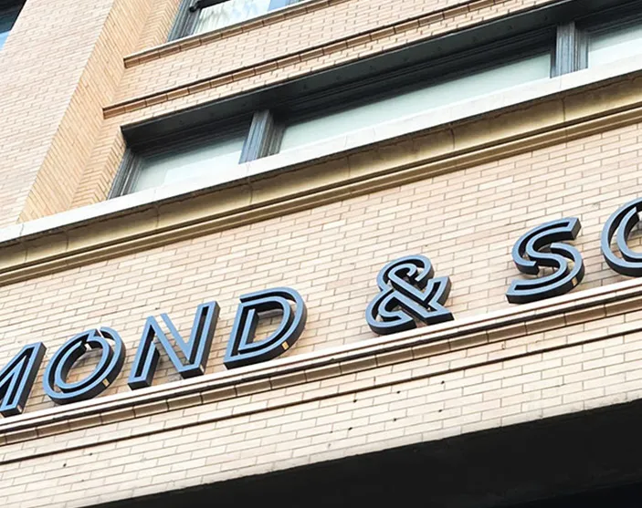 Storefront signage integrated with building architecture.